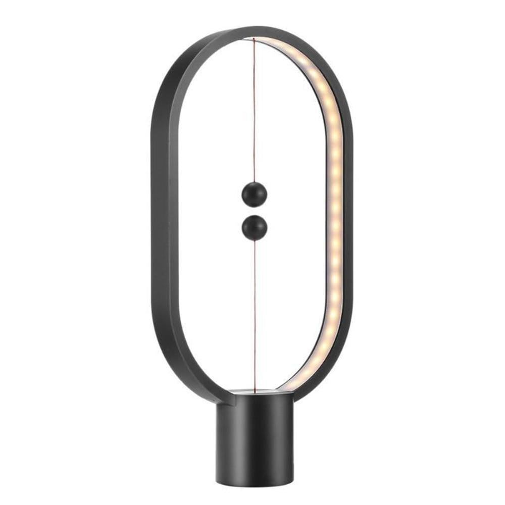 Stylish magnetic lamp illuminating a cozy room"
"Contemporary desk lamp with warm LED glow"
"Balance lamp with ellipse frame and suspended magnetic switch"
"Magnetic LED table light perfect for bedroom or office"
Futuristic LED ellipse lamp with interactive magnetic design
Elegant bedside lamp with balance-inspired magnetic lighting