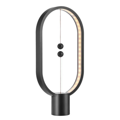 Stylish magnetic lamp illuminating a cozy room"

"Contemporary desk lamp with warm LED glow"

"Balance lamp with ellipse frame and suspended magnetic switch"

"Magnetic LED table light perfect for bedroom or office"

Futuristic LED ellipse lamp with interactive magnetic design
Elegant bedside lamp with balance-inspired magnetic lighting